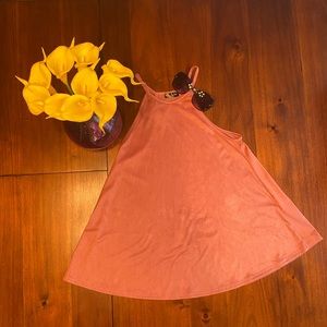 Sleeveless shirt. Peach in color.